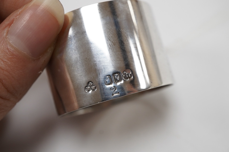 A cased set of six George V Irish silver napkin ring's, each engraved with a dear and harp on a rocky mound with tower and dated 1924, Wakely & Wheeler, Dublin, 1923.